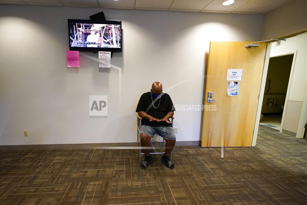Darron Cummings Larry Brown waits in the lobby at the Community Health Network for his occupational therapy session, Thursday, Aug. 20, 2020, in Indianapolis. The former Indiana State football player who brags about catching everything on the field now has hand therapy twice a week. (AP Photo/Darron Cummings)
