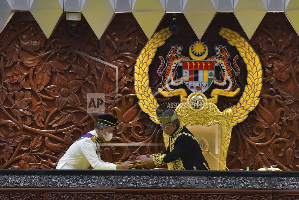 Nazri Rapai In this photo released by Malaysia's Department of Information, Malaysia's King Sultan Abdullah Sultan Ahmad Shah, right, receives documents from Prime Minister Muhyiddin Yassin during the opening ceremony of the third term of the 14th parliamentary session at parliament house in Kuala Lumpur Monday, May 18, 2020. Malaysia's parliament held an unusual half-day sitting Monday, that was kept short due to the COVID-19 pandemic and saw Prime Minister Muhyiddin Yassin dodge a vote of no-confidence against him over two months since he came into power. (Nazri Rapai/Malaysia's Department of Information via AP)
