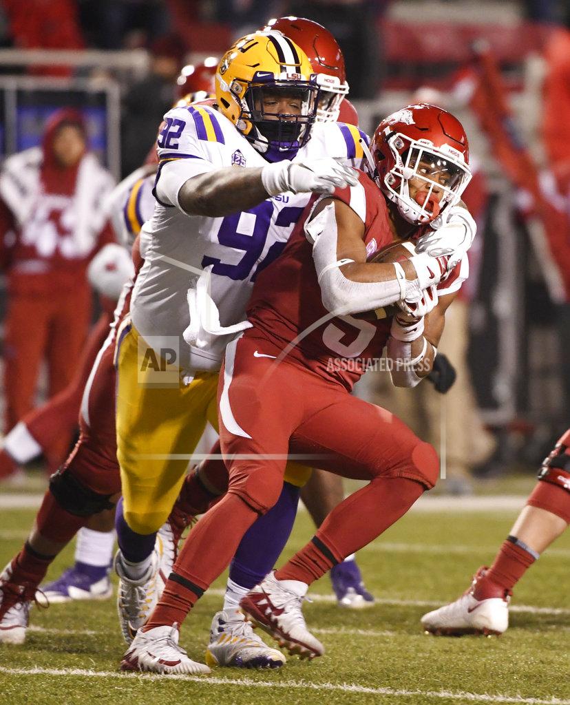 Michael Woods Arkansas running back Rakeem Boyd is tackled by LSU defender Neil Farrell Jr. during the second half of an NCAA college football game, Saturday, Nov. 10, 2018, in Fayetteville, Ark. LSU won, 24-17. (AP Photo/Michael Woods)