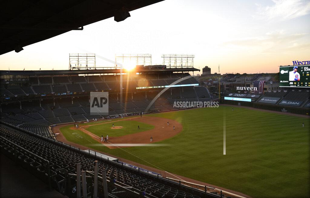 David Banks The sun sets behind Wrigley Field during the sixth inning of an opening day baseball game between the Chicago Cubs and the Milwaukee Brewers, Friday, July, 24, 2020, in Chicago. (AP Photo/David Banks)