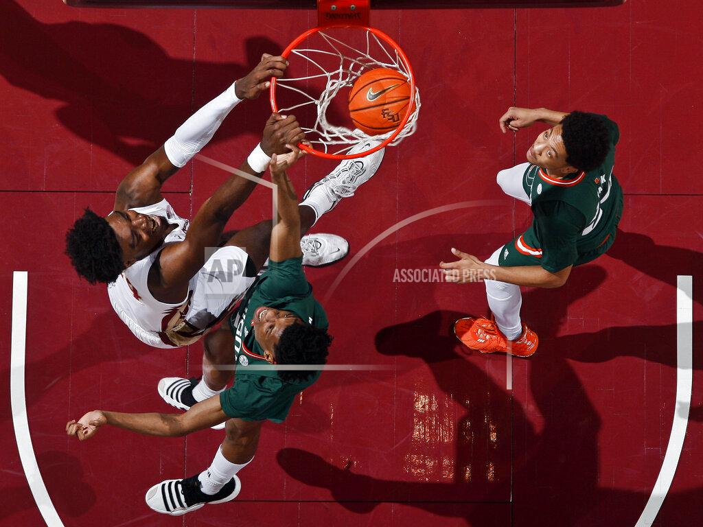 Phil Sears Florida State center Naheem McLeod (24) dunks the ball as Miami forward Anthony Walker, bottom, and Miami guard Nijel Pack, right, defend in the first half of an NCAA college basketball game in Tallahassee, Fla., Tuesday, Jan. 24, 2023. (AP Photo/Phil Sears)