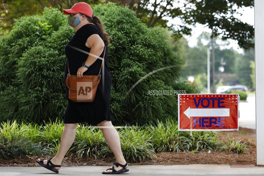 Joshua L. Jones A woman heads inside to vote in primary election at Gaines Elementary School in Athens, Ga, on Tuesday, June 9, 2020. (Joshua L. Jones/Athens Banner-Herald via AP)