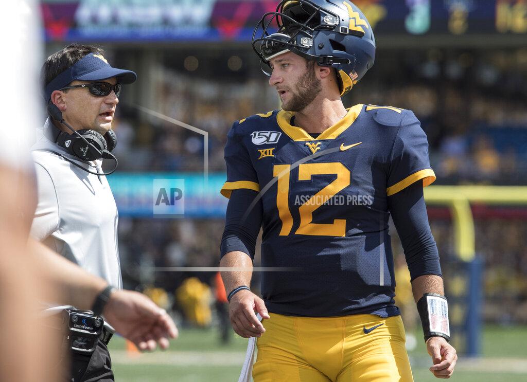Ray Thompson West Virginia head coach Neal Brown, left, and quarterback Austin Kendall, right, chat in-between plays during the first half of an NCAA college football game against James Madison Saturday, Aug. 31, 2019, in Morgantown, W.Va. (AP Photo/Raymond Thompson)