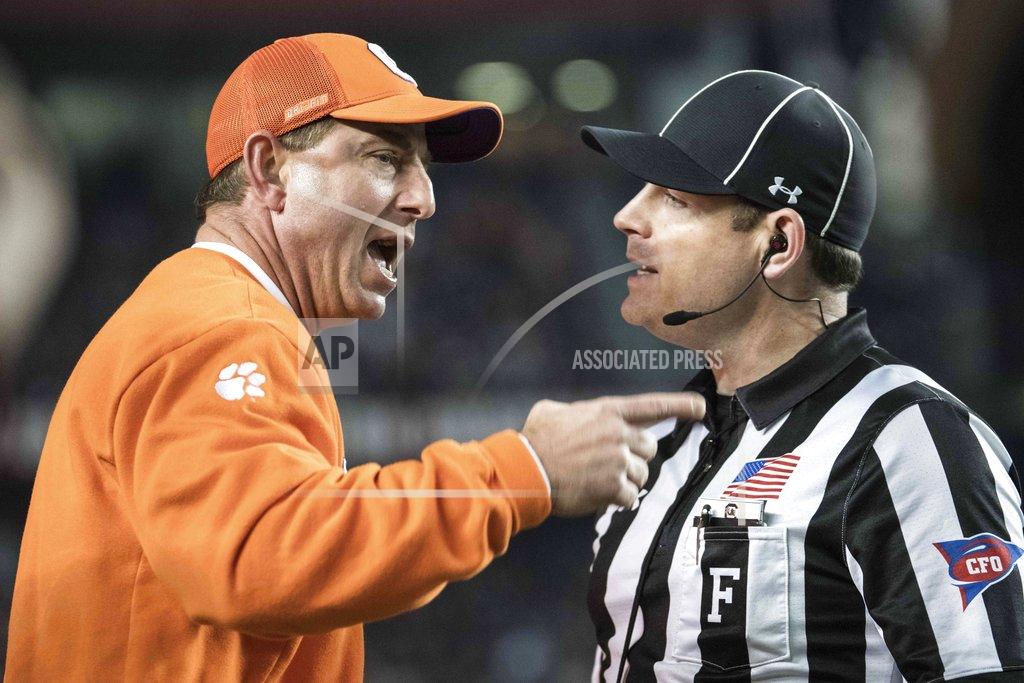 Sean Rayford Clemson head coach Dabo Swinney, left, communicates with an official during the first half of an NCAA college football game against South Carolina, Saturday, Nov. 25, 2017, in Columbia, S.C. (AP Photo/Sean Rayford)