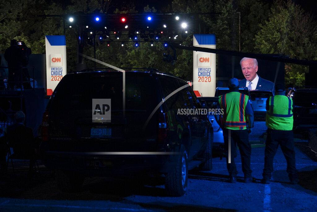 Carolyn Kaster Audience members watch from their cars as Democratic presidential candidate former Vice President Joe Biden, seen on a monitor, speaks during a CNN town hall in Moosic, Pa., Thursday, Sept. 17, 2020. (AP Photo/Carolyn Kaster)