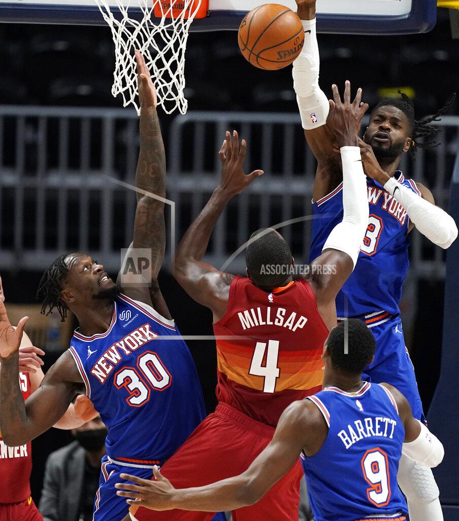 David Zalubowski Denver Nuggets forward Paul Millsap (4) drives between New York Knicks forward Julius Randle (30) and guard RJ Barrett (9) to put up a shot blocked by center Nerlens Noel in the second half of an NBA basketball game Wednesday, May 5, 2021, in Denver. (AP Photo/David Zalubowski)