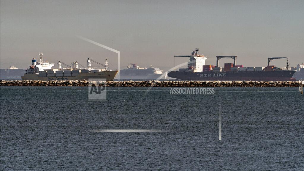 Damian Dovarganes In this Feb. 19, 2021 photo, high number of container ships, a cruise ship, and a small sail boat, dot the coast of Long Beach waiting to dock at the Ports of Los Angeles and Long Beach off the California Coast. A trade bottleneck born of the COVID-19 outbreak has U.S. businesses waiting for shipments from Asia _ while off the coast of California, dozens of container ships have been anchored, unable to unload their cargo. (AP Photo/Damian Dovarganes)