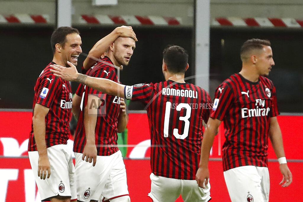 Antonio Calanni AC Milan's Ante Rebic, center left, celebrates with his teammates his goal against Juventus during the Serie A soccer match between AC Milan and Juventus at the San Siro stadium, in Milan, Italy, Tuesday, July 7, 2020. (AP Photo/Antonio Calanni)