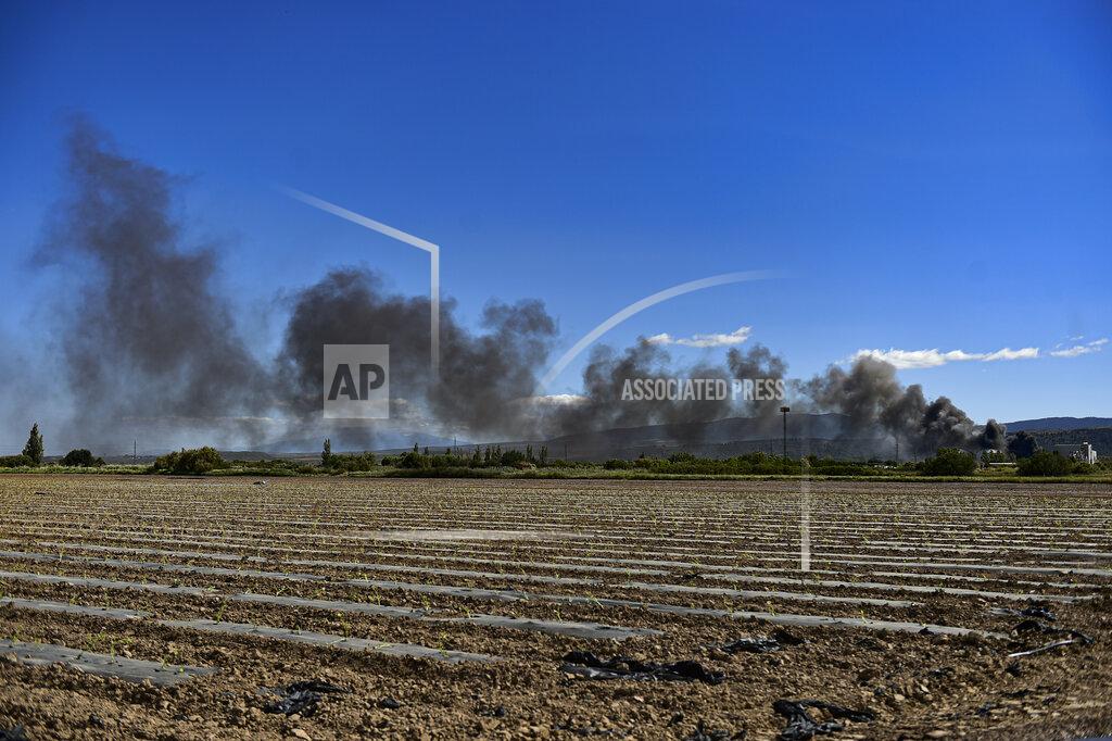 Alvaro Barrientos Black smoke billows from a biodiesel production plant in Calahorra, northern Spain, Thursday, May 26, 2022. Police in Spain say an explosion at a biodiesel plant has left two people dead and forced 250 children to be evacuated from the area. (AP Photo/Alvaro Barrientos)
