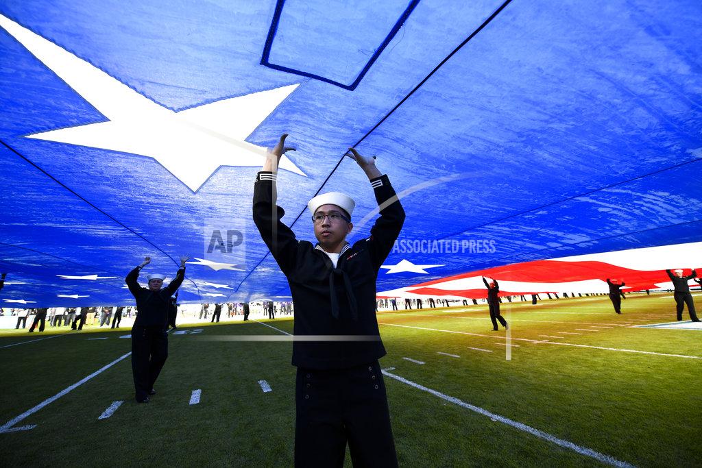 Denis Poroy United States Navy sailors hold up a giant U.S. flag before the Holiday Bowl NCAA college football game between Utah and Northwestern, Monday, Dec. 31, 2018, in San Diego. (AP Photo/Denis Poroy)