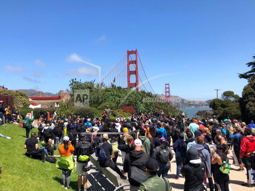 Jeff Chiu Dozens of people gather by the Golden Gate Bridge Welcome Center in San Francisco Saturday, June 6, 2020, to begin marching across the famous span in support of the Black Lives Matter movement. (AP Photo/Jeff Chiu)