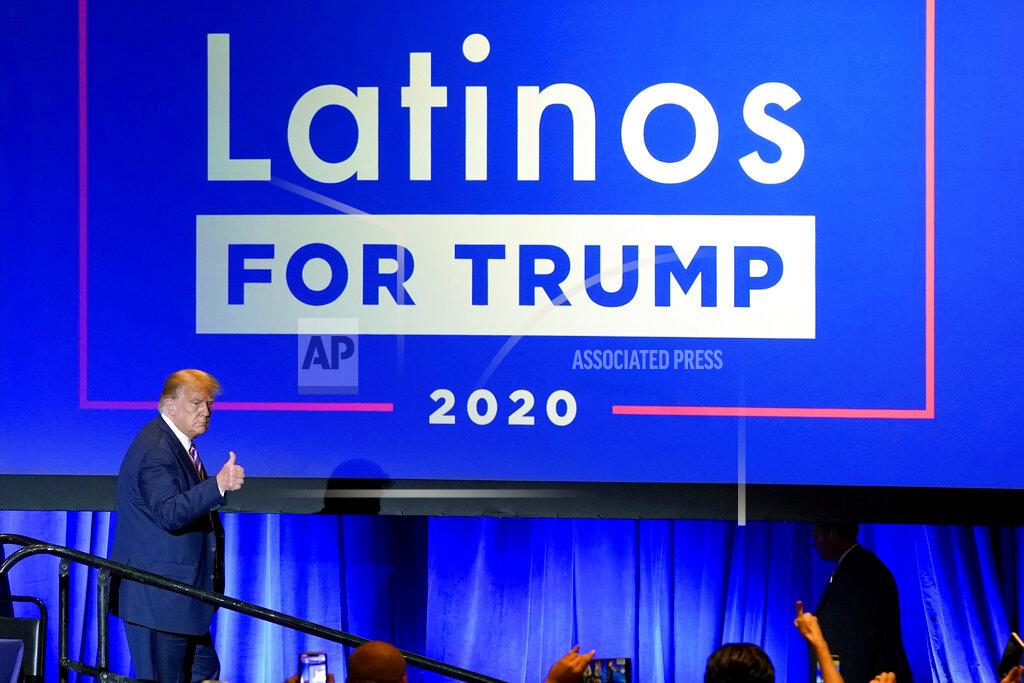 Ross D. Franklin FILE - In this Sept. 14, 2020 file photo, President Donald Trump give a thumbs up to the cheering crowd after a Latinos for Trump Coalition roundtable in Phoenix. President Donald Trump is putting up a fight for Latino voters in key swing states with Democratic candidate Joe Biden. Polls show Biden with a commanding overall lead with Hispanic voters, a diverse group that defies neat political categories. Still, about 3 in 10 registered Latino voters nationwide back Trump, roughly consistent with how Latinos voted in 2018 congressional elections and in 2016. Latino men, like men of other races, support Trump more than Hispanic women. (AP Photo/Ross D. Franklin, File)