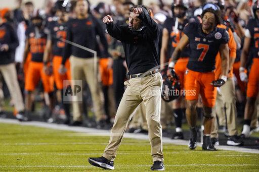Oklahoma State coach Mike Gundy gestures during the second half of the team's NCAA college football game against Oklahoma, Saturday, Nov. 27, 2021, in Stillwater, Okla. (AP Photo/Sue Ogrocki)