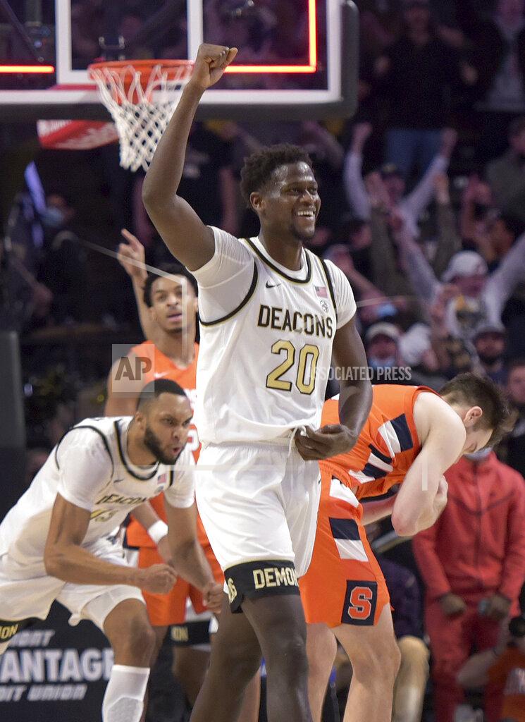 Walt Unks Wake Forest's Khadim Sy (20) and Dallas Walton celebrate as Syracuse's last second shot fails during the second half of an NCAA college basketball game, Saturday, Jan. 8, 2022 at Joel Coliseum in Winston-Salem, N.C. (Walt Unks/The Winston-Salem Journal via AP)
