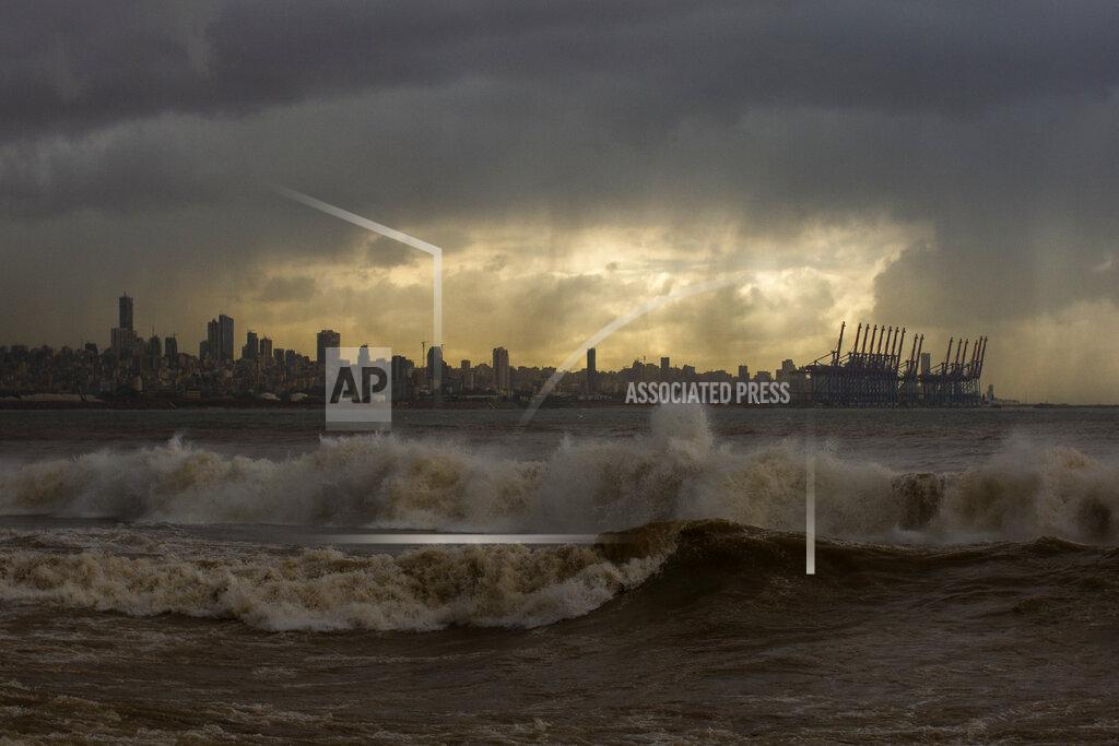 Hassan Ammar Heavy clouds hover over Beirut as waves crash on the seawall of the corniche, in Dbayeh, Lebanon, Wednesday, Feb. 17, 2021. Storm Joyce hit late Tuesday with gale force winds registering up to 100 km/h (62 miles/h). (AP Photo/Hassan Ammar)