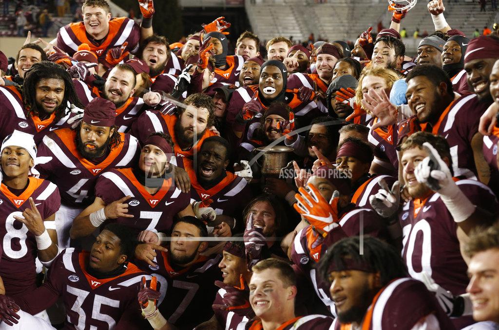 Steve Helber Members of the Virginia Tech football team celebrate their overtime win over Virginia after an NCAA college football game in Blacksburg, Va., Friday, Nov. 23, 2018. Virginia Tech defeated Virginia 34-31. (AP Photo/Steve Helber)
