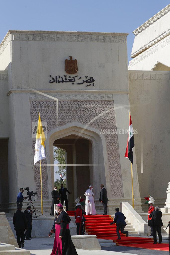 Andrew Medichini Pope Francis is welcomed by Iraqi President Barham Salih, at Baghdad's Presidential Palace, Iraq, Friday, March 5, 2021. Pope Francis has arrived in Iraq to urge the country's dwindling number of Christians to stay put and help rebuild the country after years of war and persecution, brushing aside the coronavirus pandemic and security concerns. (AP Photo/Andrew Medichini)