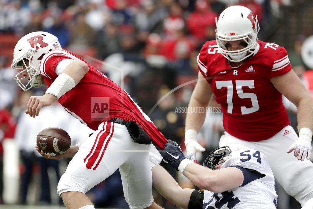 Julio Cortez Penn State defensive tackle Robert Windsor, bottom right, grabs at the jersey of Rutgers quarterback Artur Sitkowski, left, while recording a sack during the first half of an NCAA college football game, Saturday, Nov. 17, 2018, in Piscataway, N.J. Rutgers' Zach Venesky (75) looks on during the play. (AP Photo/Julio Cortez)