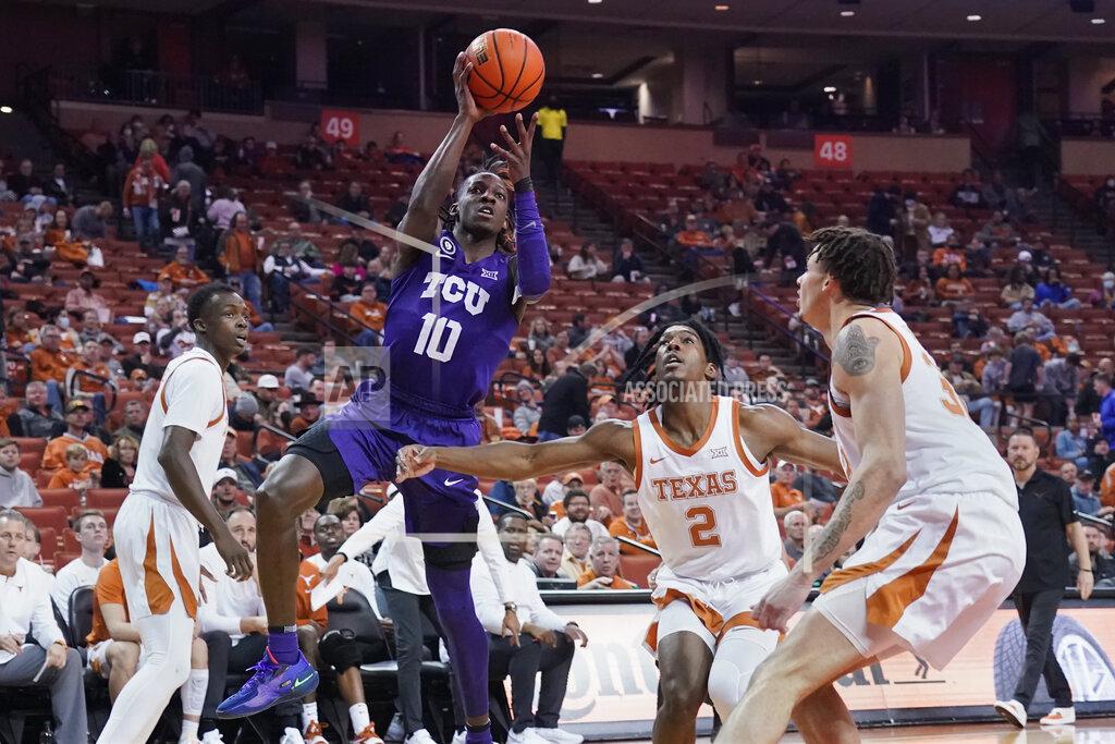 Chuck Burton TCU guard Damion Baugh (10) shoots against Texas guard Marcus Carr (2) and forward Christian Bishop (32) during the first half of an NCAA college basketball game in Austin, Texas, Wednesday, Feb. 23, 2022. (AP Photo/Chuck Burton)