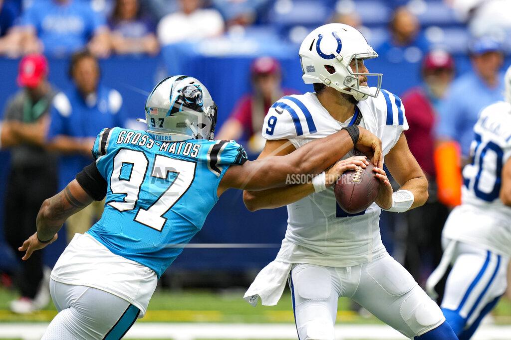 Aj Mast Carolina Panthers defensive end Yetur Gross-Matos (97) tries to strip the ball from Indianapolis Colts quarterback Jacob Eason (9) during an NFL exhibition football game in Indianapolis, Sunday, Aug. 15, 2021. (AP Photo/AJ Mast)