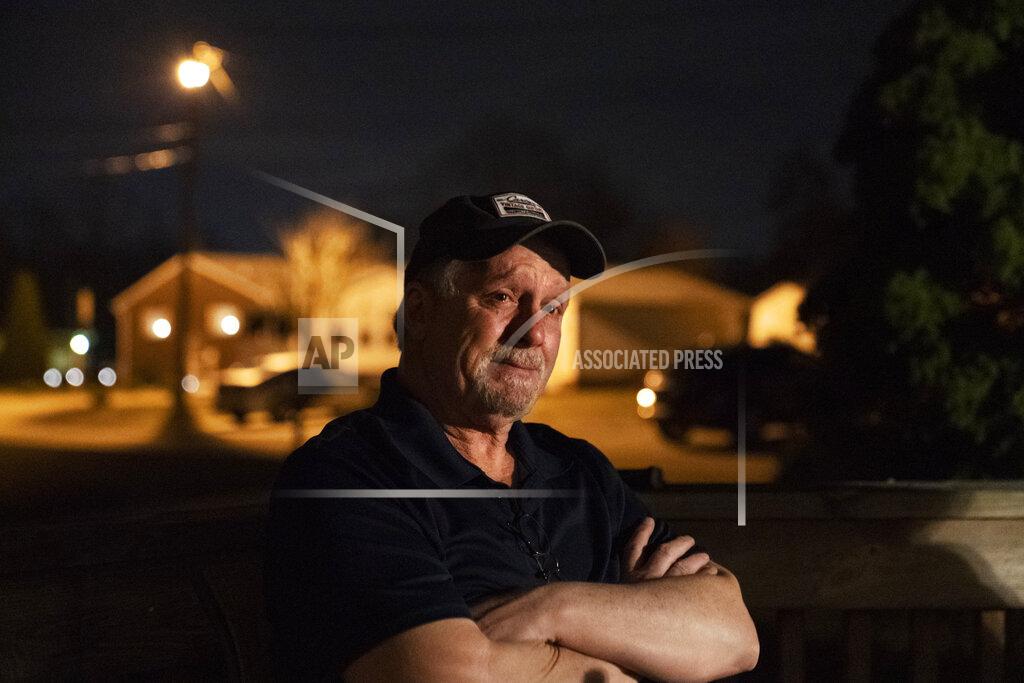 David Goldman Jeff Carter, left, becomes emotional as he remembers his daughter, Kayla, while sitting outside his home, Tuesday, March 16, 2021, in Milton, W.Va. Kayla grew up in a small town 20 miles from Huntington, in a house with a swimming pool in the backyard. She was the middle child of three daughters. Kayla had a brilliant mind for math and loved the stars. Her family always thought she'd grow up to work for NASA. Instead, she was addicted to opioids by the time she turned 20. (AP Photo/David Goldman)