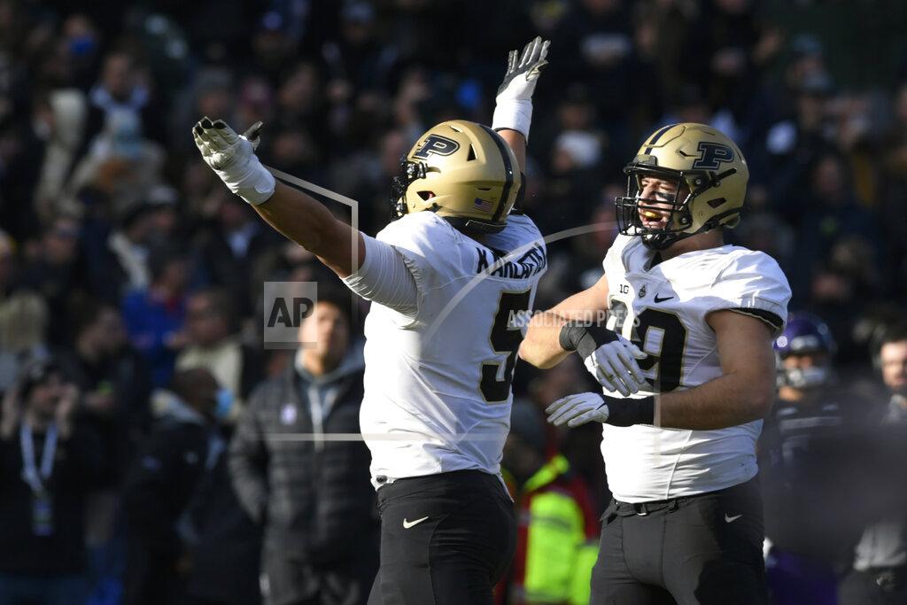 Paul Beaty Purdue's Jack Sullivan (99) and George Karlafits (5) celebrate after sacking Northwestern quarterback Ryan Hilinski (12) during the second half of a NCAA football game Nov. 20, 2021 at Wrigley Field in Chicago. Purdue won 32-14. (AP Photo/Paul Beaty)