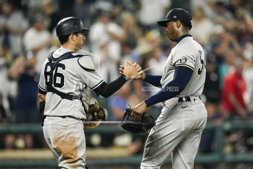 Julio Cortez New York Yankees catcher Kyle Higashioka (66) and relief pitcher Aroldis Chapman react after defeating the Baltimore Orioles 7-2 during a baseball game, Tuesday, Sept. 14, 2021, in Baltimore. (AP Photo/Julio Cortez)