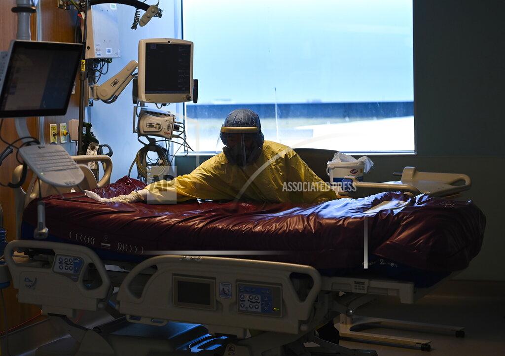 Nathan Denette An essential worker thoroughly cleans a COVID-19 patient's room after they were transferred out of the intensive care unit at the Humber River Hospital in Toronto on Tuesday, April 13, 2021. (Nathan Denette/The Canadian Press via AP)