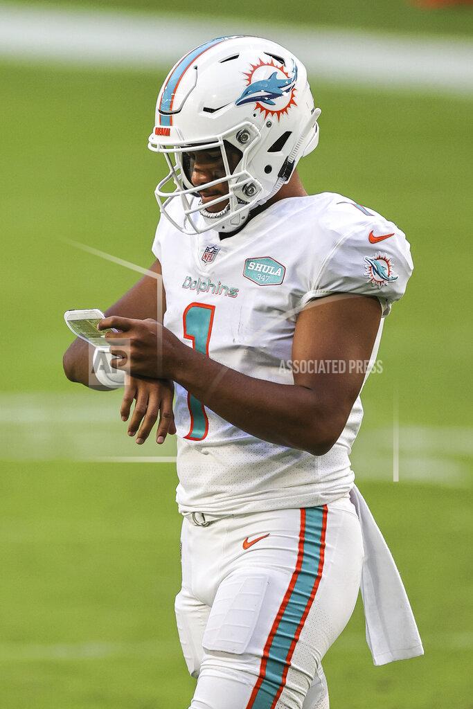 Margaret Bowles Miami Dolphins quarterback Tua Tagovailoa (1) checks the plays on his wristband during an NFL game against the Los Angeles Rams, Sunday, Nov. 1, 2020 in Miami Gardens, Fla. The Dolphins defeated the Rams 28-17. (Margaret Bowles via AP)