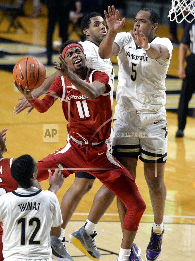 Mark Zaleski Arkansas guard Jalen Tate (11) shoots against Vanderbilt guard D.J. Harvey (5) during the second half of an NCAA college basketball game against Vanderbilt Saturday, Jan. 23, 2021, in Nashville, Tenn. Arkansas won 92-71. (AP Photo/Mark Zaleski)