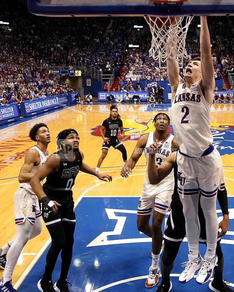 Charlie Riedel Kansas' Christian Braun (2) dunks the ball during the second half of an NCAA college basketball game against Stephen F. Austin Saturday, Dec. 18, 2021, in Lawrence, Kan. (AP Photo/Charlie Riedel)