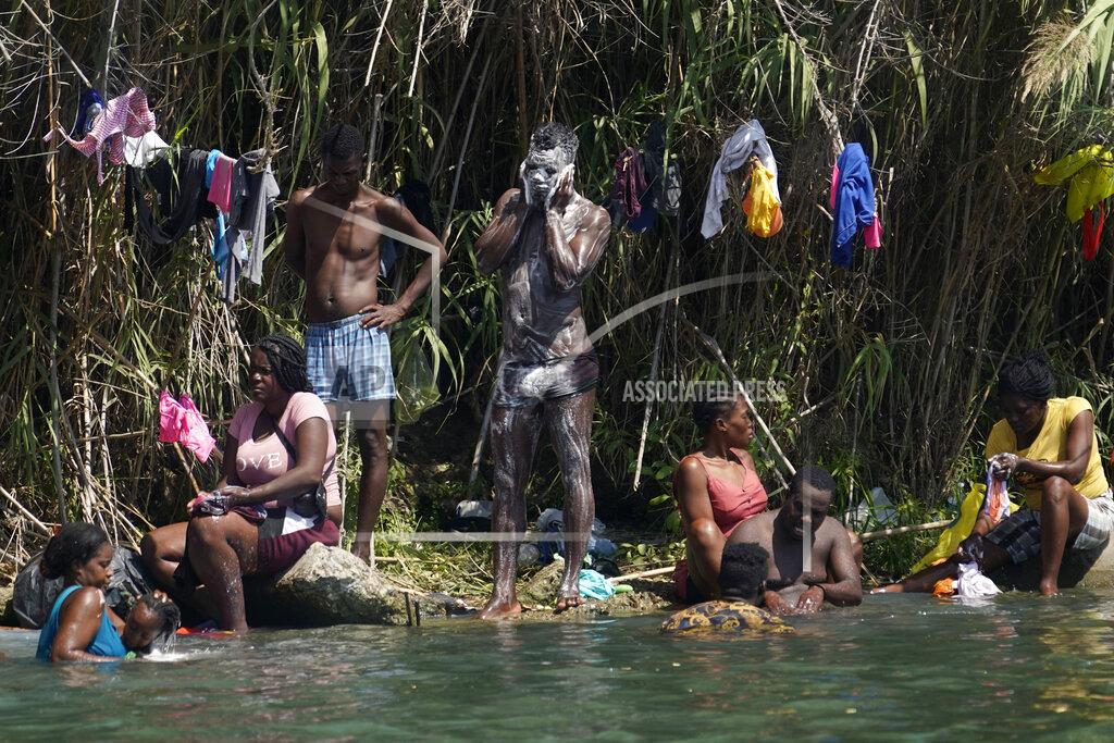 Eric Gay Haitian migrants bathe and do laundry along the banks of the Rio Grand after they crossed into the United States from Mexico, Saturday, Sept. 18, 2021, in Del Rio, Texas. (AP Photo/Eric Gay)