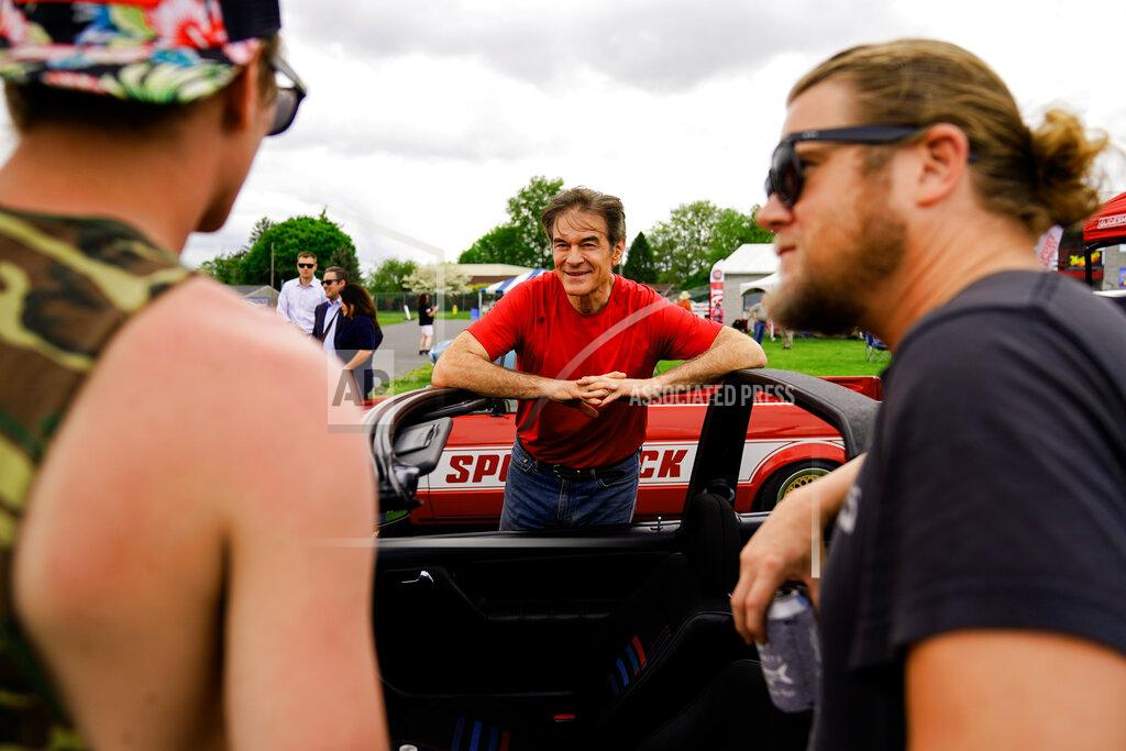 Matt Rourke Mehmet Oz, a Republican candidate for U.S. Senate in Pennsylvania, meets with attendees during a visit to a car show in Carlisle, Pa., Saturday, May 14, 2022. (AP Photo/Matt Rourke)