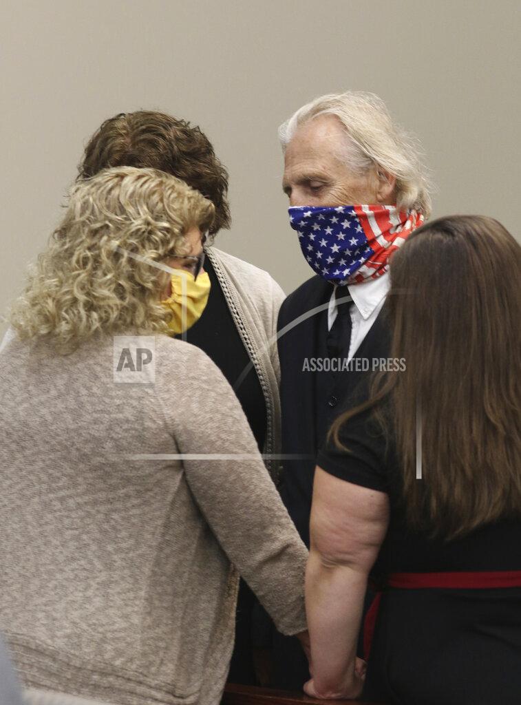 Matthew Dae Smith Former Michigan State University womens gymnastics coach Kathie Klages, left, embraces family prior to her sentencing hearing in Judge Joyce Draganchuk's courtroom Tuesday, Aug. 4, 2020, at Veteran's Memorial Courthouse in Lansing, Mich. Klages has been sentenced to 90 days in jail for lying to police during an investigation into ex-Olympic and university sports doctor Larry Nassar in 1997. (Matthew Dae Smith/Lansing State Journal via AP)