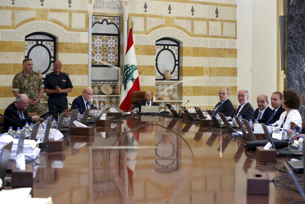 Dalati Nohra In this photo released by Lebanon's official government photographer Dalati Nohra, Lebanese president Michel Aoun, center background, and Lebanese Prime minister Najib Mikati, left background, head a cabinet meeting at the presidential palace, in Baabda, east of Beirut, Lebanon, Friday, May 20, 2022. Lebanon's government approved an economic recovery plan during its last meeting Friday before becoming a caretaker Cabinet after a new parliament was elected over the weekend, the information minister said. (Dalati Nohra/Lebanon Government via AP)