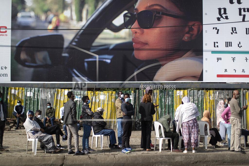 Ben Curtis Ethiopians queue on chairs in the street, underneath a billboard for an eye clinic, as they wait to cast their votes in the general election at a polling center in the capital Addis Ababa, Ethiopia Monday, June 21, 2021. Ethiopia was voting Monday in the greatest electoral test yet for Prime Minister Abiy Ahmed as insecurity and logistical issues meant ballots wouldn't be cast in more than 100 constituencies of the 547 across the country. (AP Photo/Ben Curtis)