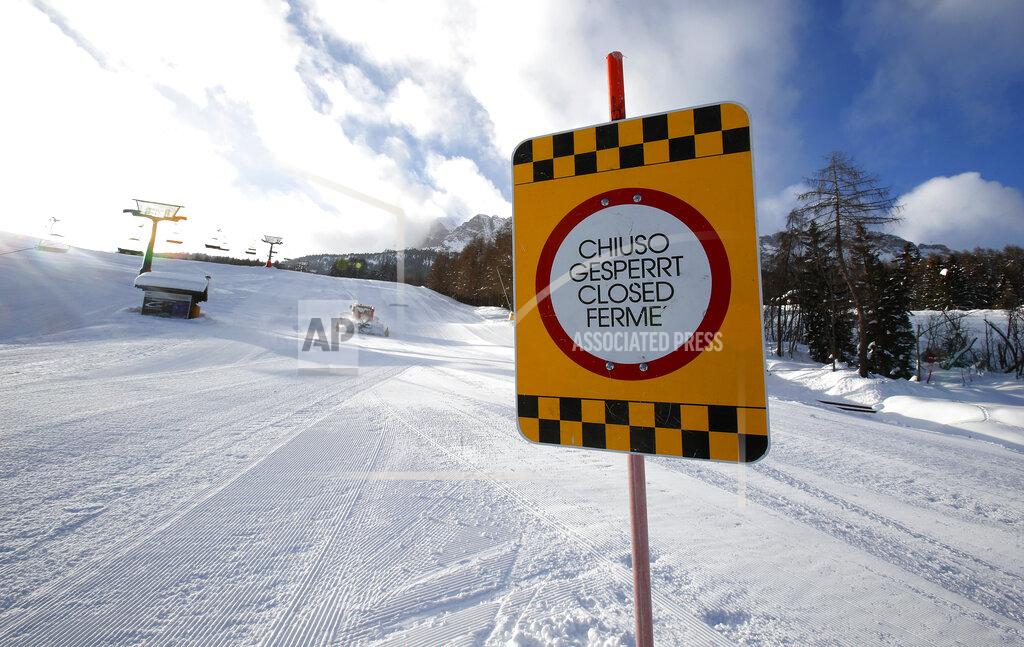 Antonio Calanni FILE - In this Jan. 28, 2021 file photo, a sign marks the closed ski slope in Cortina D'Ampezzo , Italy. On the eve of what was supposed to finally be the repeatedly delayed opening of Italy’s ski slopes, the government on Sunday, Feb. 14, 2021, yanked permission because a coronavirus variant was found to be circulating in a good portion of recently infected persons. Health Minister Roberto Speranza’s ordinance forbids amateur skiing at least until March 5. (AP Photo/Antonio Calanni)