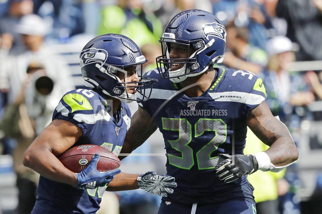John Froschauer Seattle Seahawks running back Chris Carson (32) celebrates with wide receiver Tyler Lockett, left, after Lockett scored a touchdown against the Cincinnati Bengals during the second half of an NFL football game Sunday, Sept. 8, 2019, in Seattle. (AP Photo/John Froschauer)