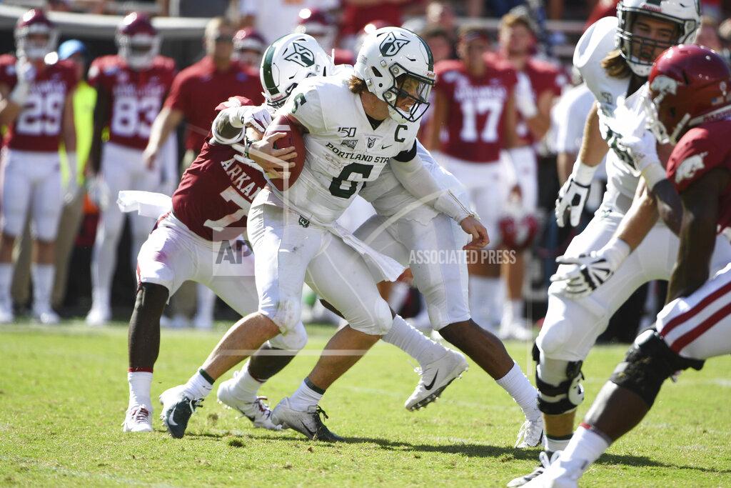 Michael Woods Portland State quarterback Davis Alexander tries to get away from Arkansas defender Joe Foucha as he scrambles out of the pocket in the first half of an NCAA college football game, Saturday, Aug. 31, 2019 in Fayetteville, Ark. (AP Photo/Michael Woods)