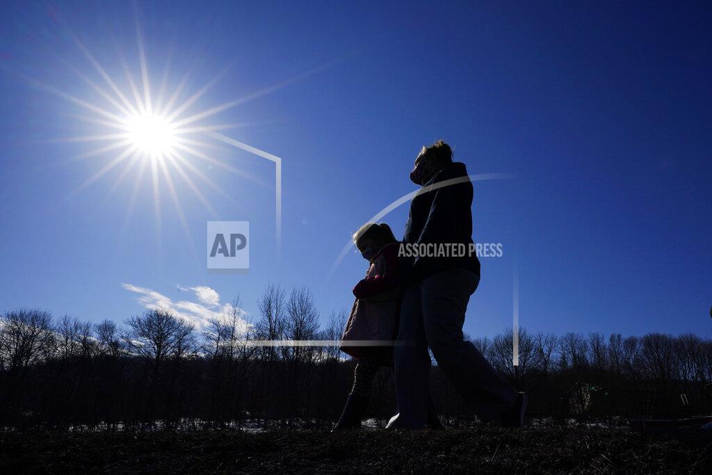 Matt Slocum Kacie Thompson, left, 9, walks with her mother, Melissa Weirich, after visiting the former home of Kacie's friend, Ava Lerario, Thursday, March 11, 2021, in Lansford, Pa. On May 26, 2020, 9-year-old Ava; her mother, Ashley Belson, and Ava's father, Marc Lerario, were found fatally shot. (AP Photo/Matt Slocum)