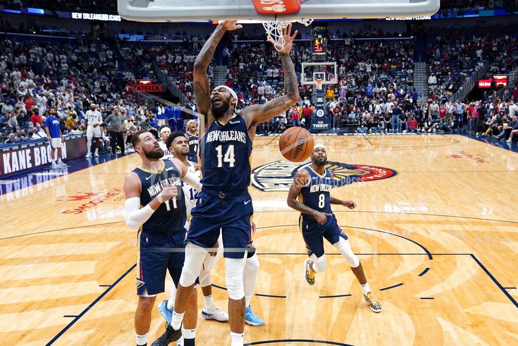 Gerald Herbert New Orleans Pelicans forward Brandon Ingram (14) slam dunks in the first half of an NBA basketball game against the Philadelphia 76ers in New Orleans, Wednesday, Oct. 20, 2021. (AP Photo/Gerald Herbert)
