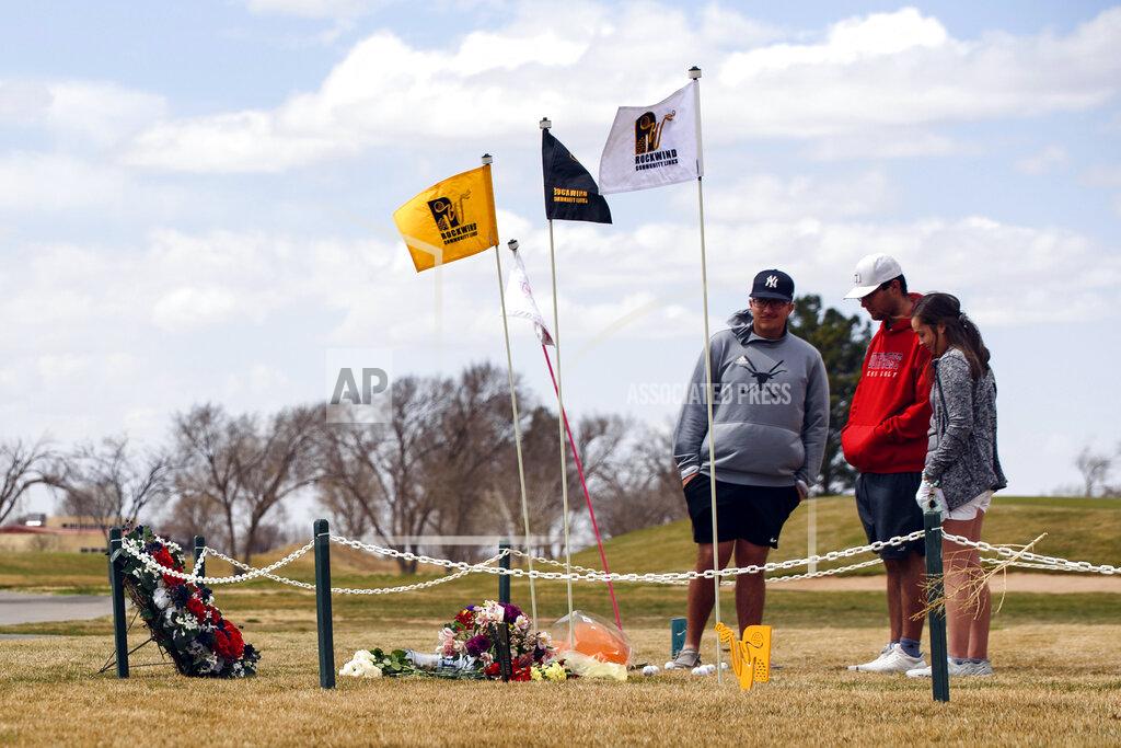 Eli Hartman University of the Southwest golf players, from left, Phillip Lopez, Jonny Flores and Halie Cruz visit the site of a memorial, Thursday, March 17, 2022 at the Rockwind Community Links in Hobbs, N.M., erected for the victims of the USW golf team's vehicle crash. (Odessa American/Odessa American via AP)