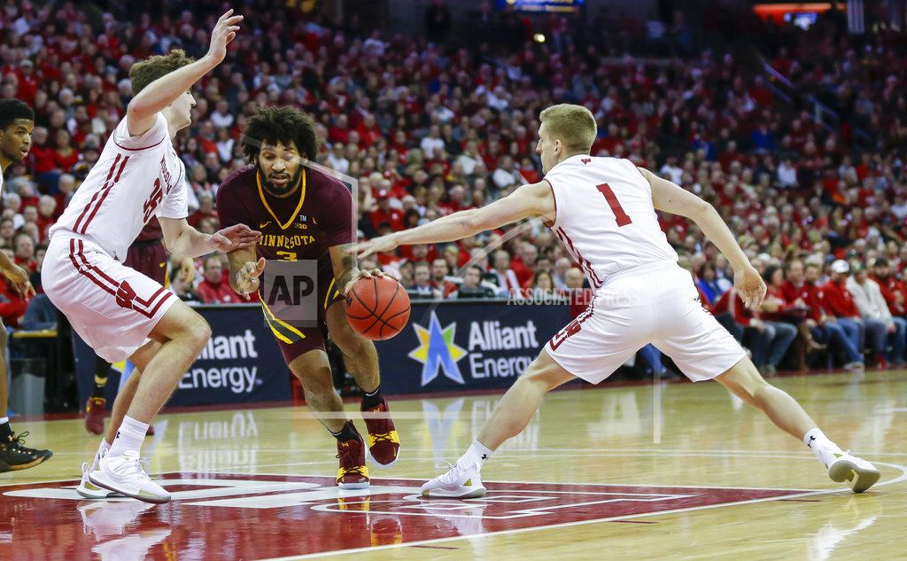 Andy Manis Minnesota's Jordan Murphy (3) drives between Wisconsin's Nate Reuvers (35) and Brevin Pritzl (1) during the first half of an NCAA college basketball game Thursday, Jan. 3, 2019, in Madison, Wis. (AP Photo/Andy Manis)
