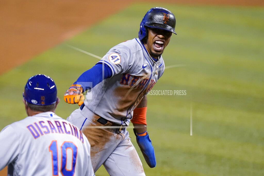 Lynne Sladky New York Mets' Francisco Lindor runs past third base to score on a throwing error by Miami Marlins center fielder Magneuris Sierra during the first inning of a baseball game, Friday, May 21, 2021, in Miami. (AP Photo/Lynne Sladky)