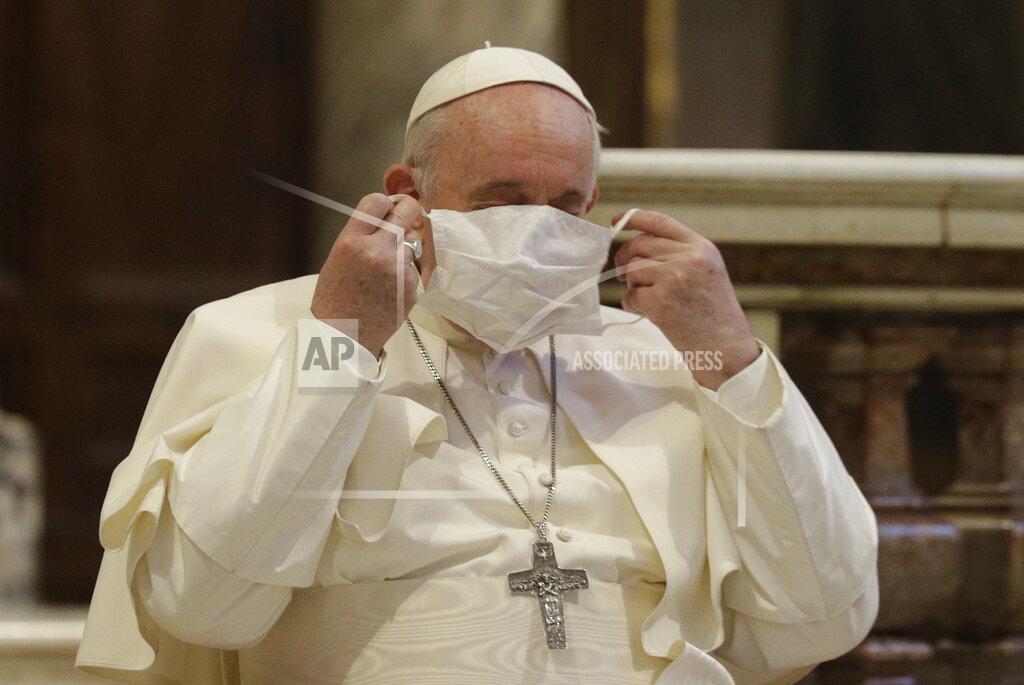 Gregorio Borgia Pope Francis puts on his face mask as he attends an inter-religious ceremony for peace in the Basilica of Santa Maria in Aracoeli, in Rome Tuesday, Oct. 20, 2020 (AP Photo/Gregorio Borgia)