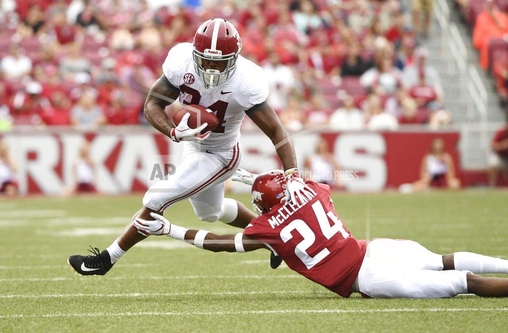 Michael Woods Alabama running back Damien Harris slips past Arkansas defender Jarques McClellion as he runs for a big gain in the first half of an NCAA college football game Saturday, Oct. 6, 2018, in Fayetteville, Ark. (AP Photo/Michael Woods)