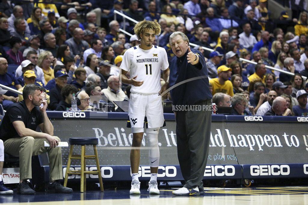 Kathleen Batten West Virginia coach Bob Huggins speaks with West Virginia forward Emmitt Matthews Jr. (11) after a play during the second half of an NCAA college basketball game Monday, Jan. 20, 2020, in Morgantown, W.Va. (AP Photo/Kathleen Batten)