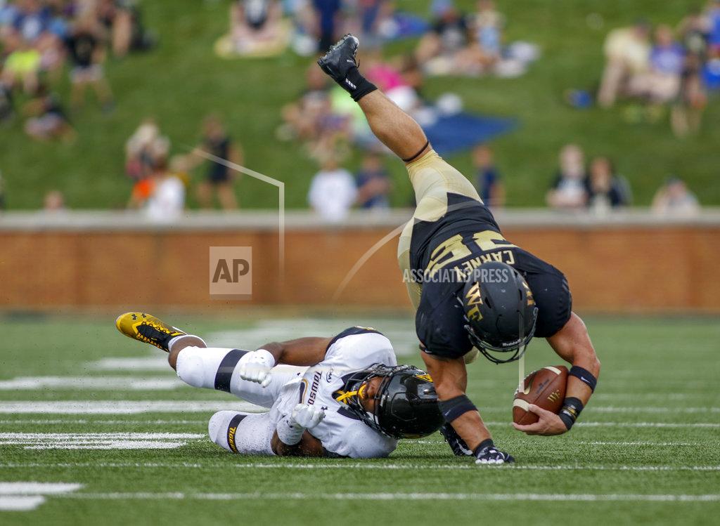 Nell Redmond Wake Forest running back Cade Carney dives over Towson defensive back Jamal Gay in the second half of an NCAA college football game in Winston-Salem, N.C., Saturday, Sept. 8, 2018. (AP Photo/Nell Redmond)