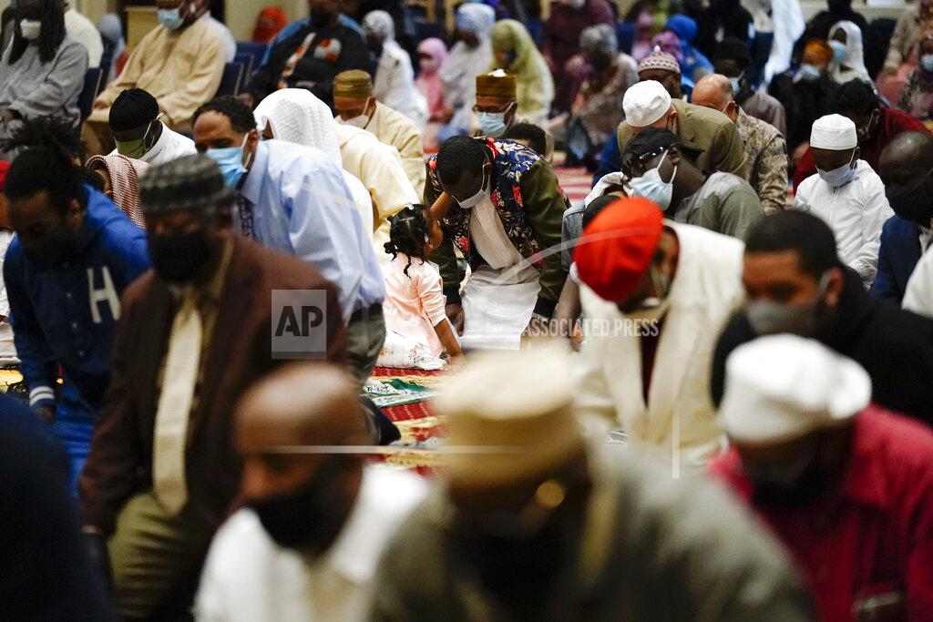 Matt Rourke Worshippers perform an Eid al-Fitr prayer at the Masjidullah Mosque in Philadelphia, Thursday, May 13, 2021. Millions of Muslims across the world are marking a muted and gloomy holiday of Eid al-Fitr, the end of the fasting month of Ramadan - a usually joyous three-day celebration that has been significantly toned down as coronavirus cases soar. (AP Photo/Matt Rourke)