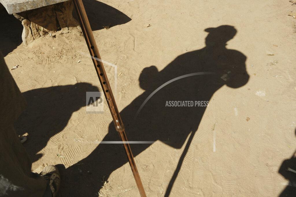 Tsvangirayi Mukwazhi An elderly man takes a walk at the Society for the Destitute Aged care home in Harare's Highfield township, Zimbabwe, Saturday June, 26, 2021. The economic ravages of COVID-19 are forcing some families in Zimbabwe to abandon the age old tradition of taking care of the elderly. Zimbabwe's care homes have experienced a 60% increase in admissions since the outbreak of the pandemic in March last year. (AP Photo/Tsvangirayi Mukwazhi)